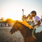 man riding brown horse