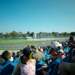 Spectators watch a race from the stands.